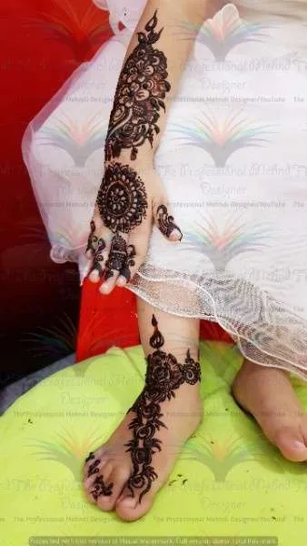 babygirl with white dress and foot and hand mehndi