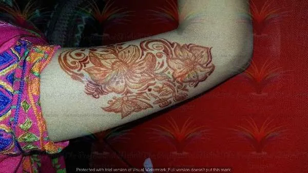 flower and butterfly on shoulder with cone mehndi