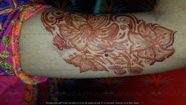 flower and butterfly on shoulder with cone mehndi