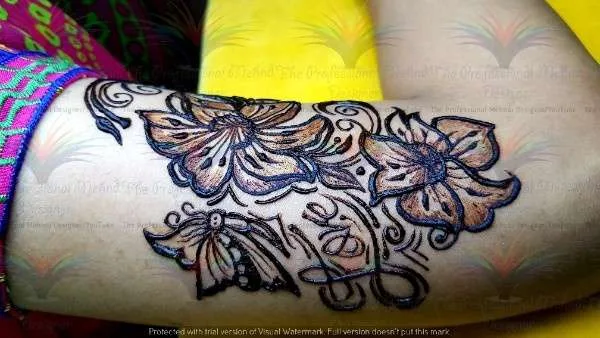 mehndi design of flower and butterfly on shoulder with cone