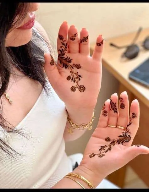 250+ Best Mehndi Designs for Hand Picture and Videos 143 beautiful girl with beautiful hand applying mehndi design on both hand