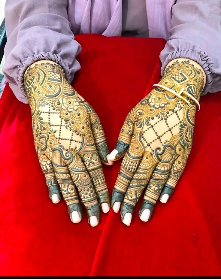 250+ Best Mehndi Designs for Hand Picture and Videos 105 back side mehdi desings showing both hand with red background and wearig blue shirt
