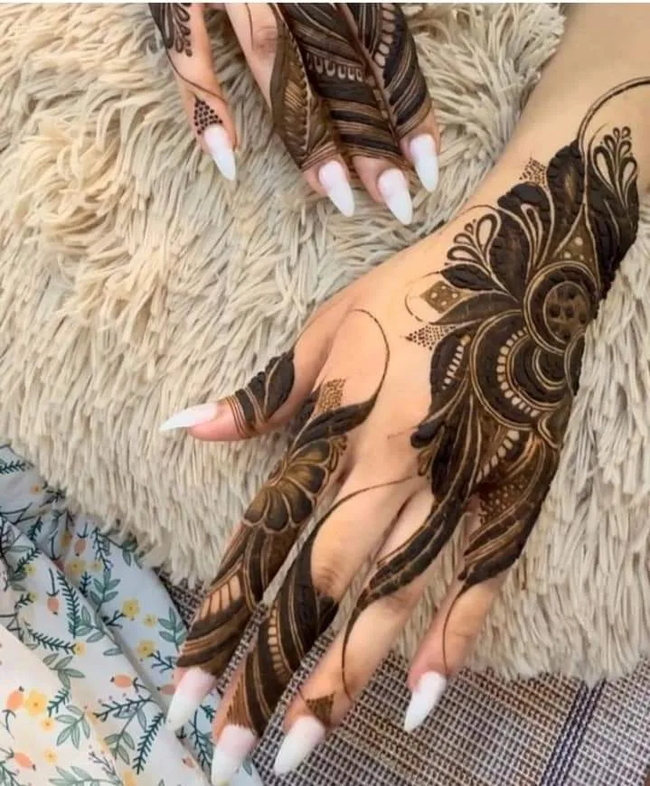 250+ Best Mehndi Designs for Hand Picture and Videos 101 back side mehndi design placing hand on knee