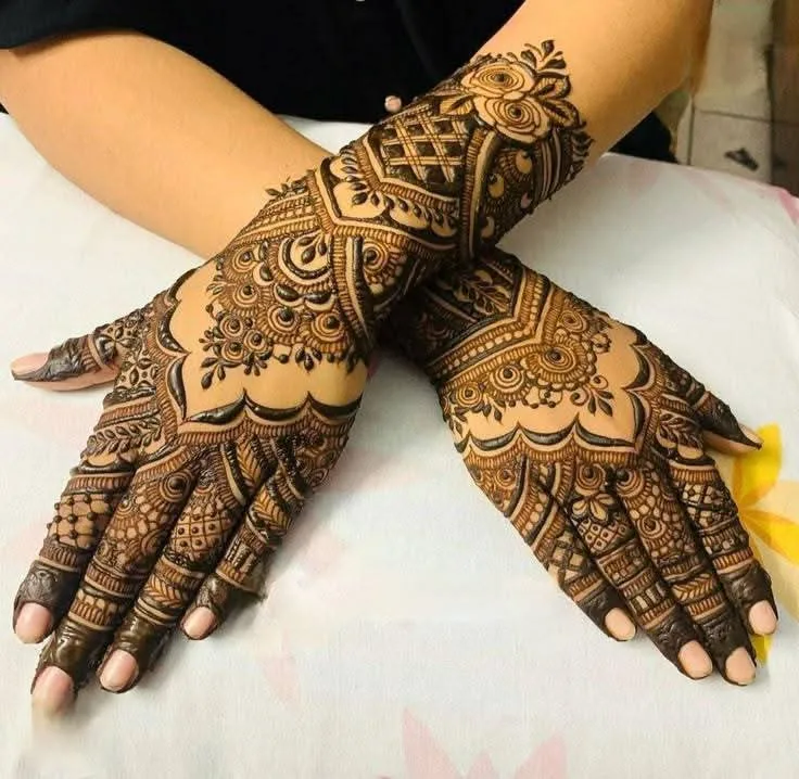250+ Best Mehndi Designs for Hand Picture and Videos 100 back side mehndi design showig with cross hand placing