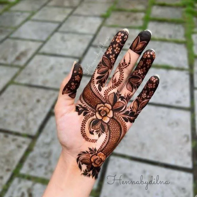 250+ Best Mehndi Designs for Hand Picture and Videos 76 female showing front hand mehndi design made flower on plam side
