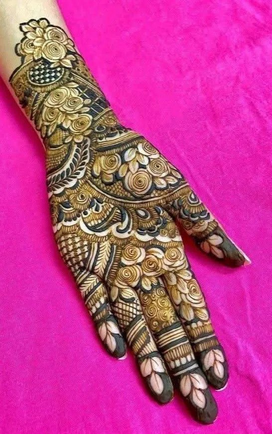 250+ Best Mehndi Designs for Hand Picture and Videos 66 front hand mehndi desing full hand mehndi placing hand on colourfull cloth