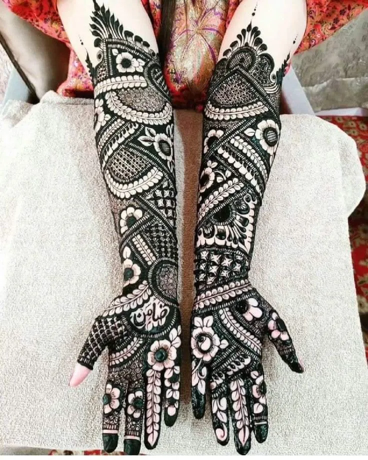250+ Best Mehndi Designs for Hand Picture and Videos 60 full hand front mehndi design on both hand placing hand on her knee