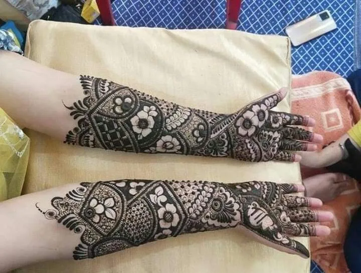 250+ Best Mehndi Designs for Hand Picture and Videos 50 full mehndi applied on hand and place on a table