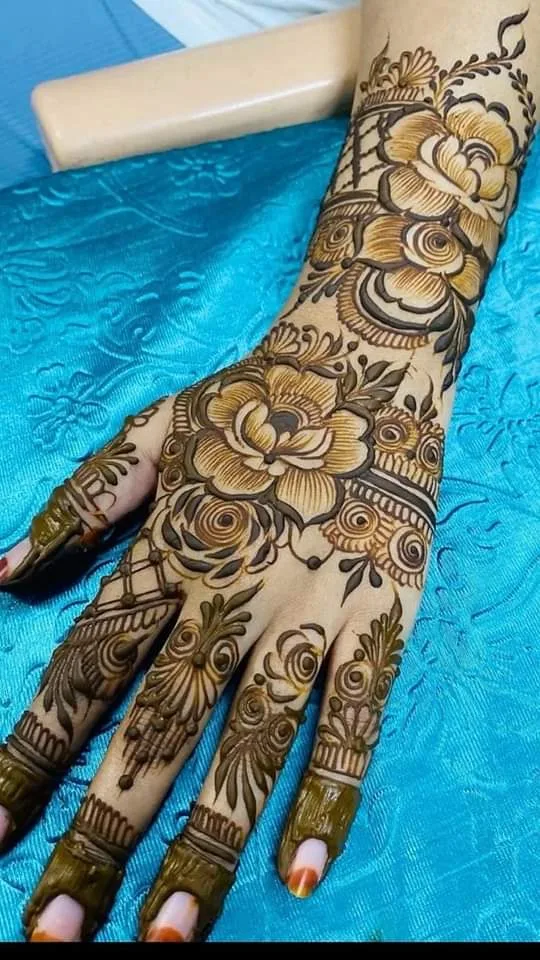 250+ Best Mehndi Designs for Hand Picture and Videos 35 mehndi design hand back side with blue backgroud