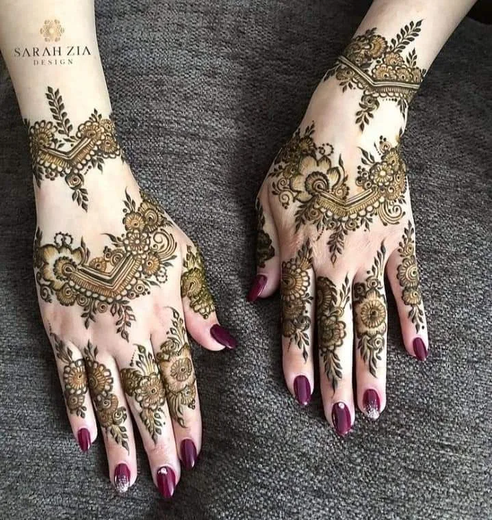 50 Best Backhand Mehndi Design Pictures and Videos 60 placing hand on towel and showing back hand mehndi design of both hand