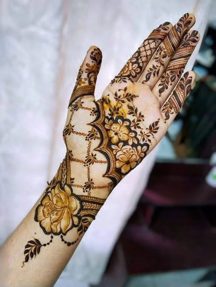250+ Best Mehndi Designs for Hand Picture and Videos 11 showing front hand mehndi design with white curtain on background