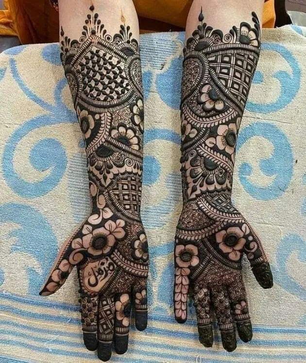 250+ Best Mehndi Designs for Hand Picture and Videos 7 showing full hand mehndi design both hand placing hand on blue clour cloth
